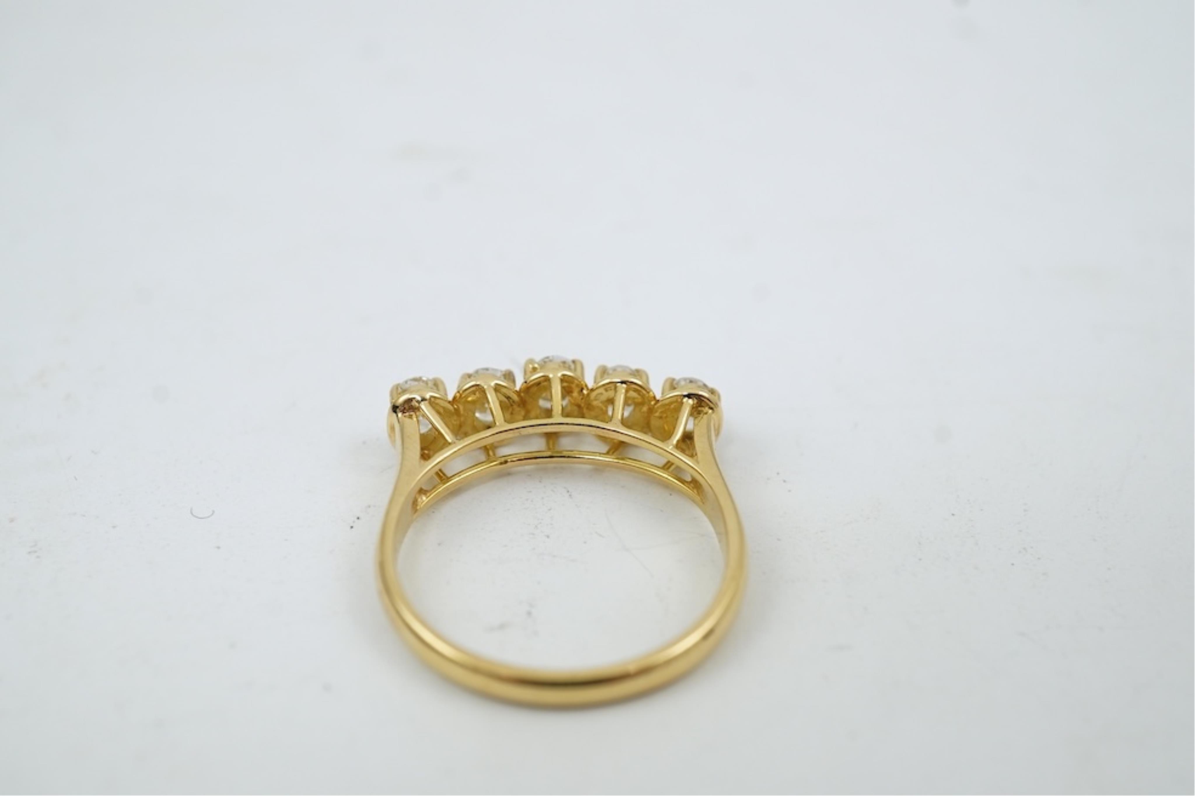 A modern 18ct gold and five stone oval cut diamond set half hoop ring, size N, gross weight 3.8 grams.
